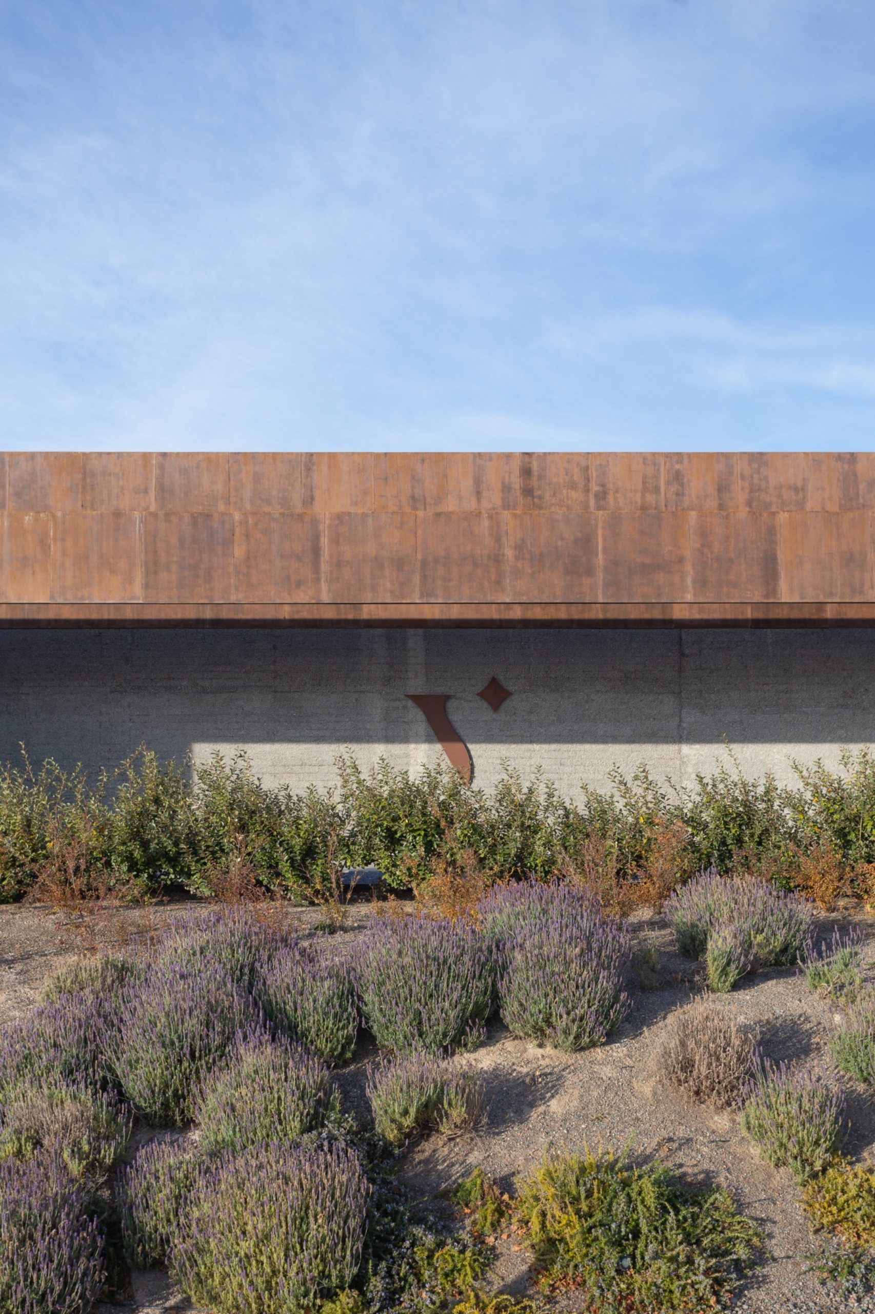 Oxidized metal crown above black concrete at La Vigilia Winery