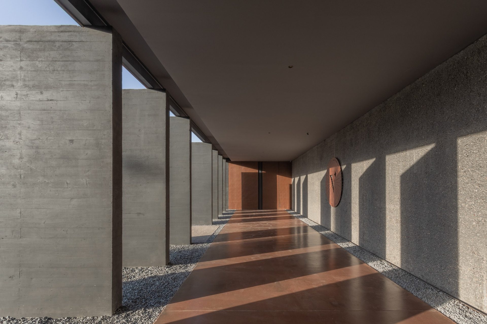 Covered walkway with light and shadow bands at La Vigilia Winery