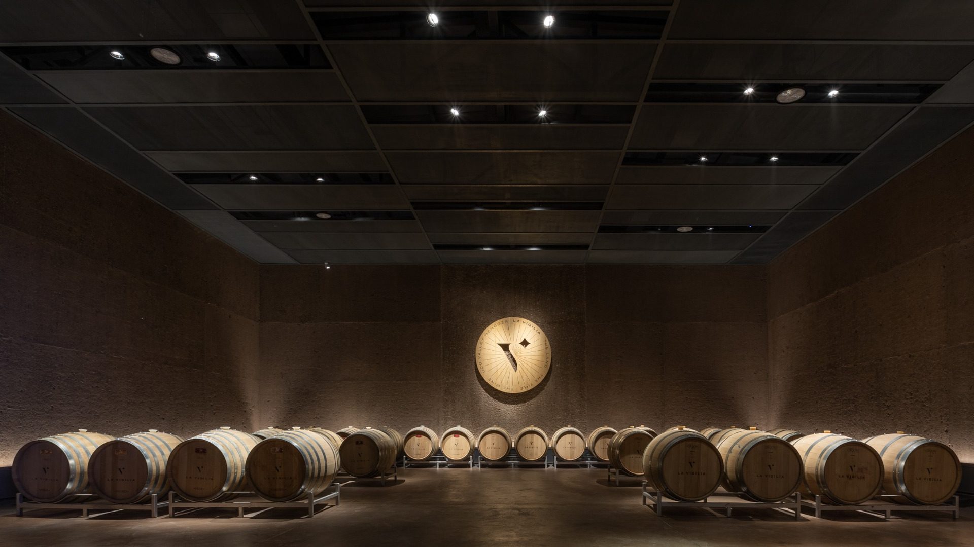 Barrel room with low lighting at La Vigilia Winery