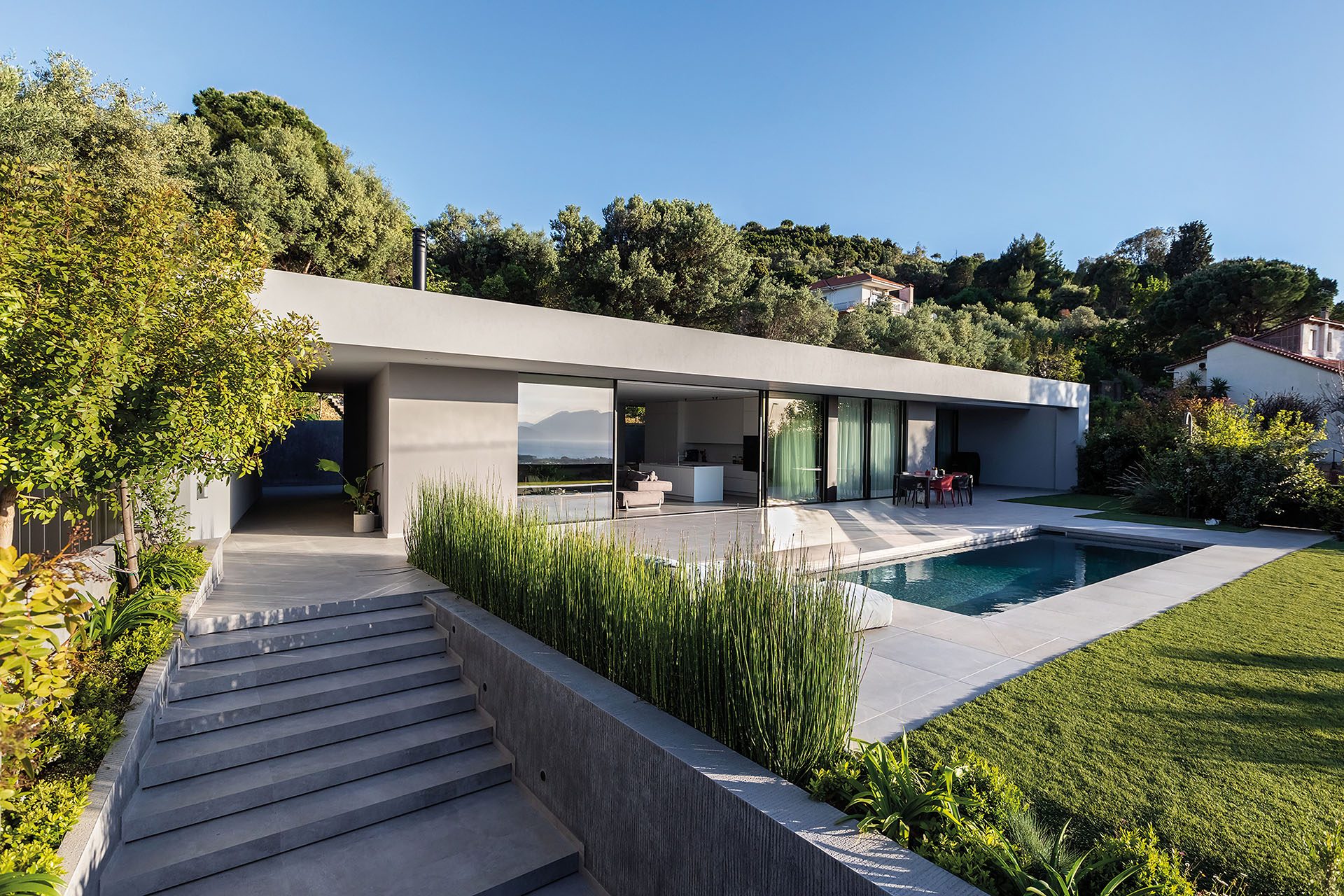 Residence in Achaia linear shell with steps, planting, pool and lawn