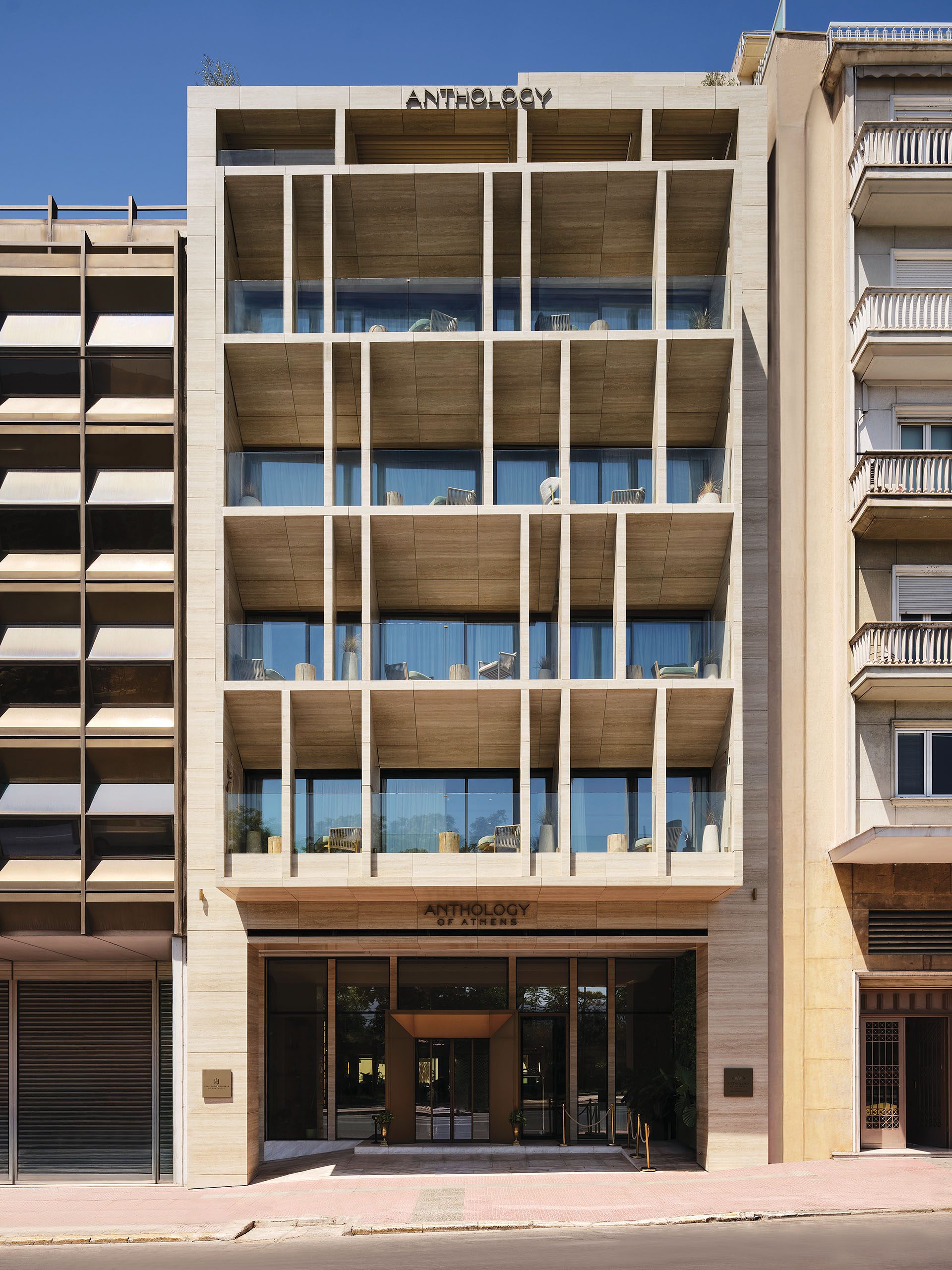 Anthology of Athens street façade with vertical elements and framed balconies