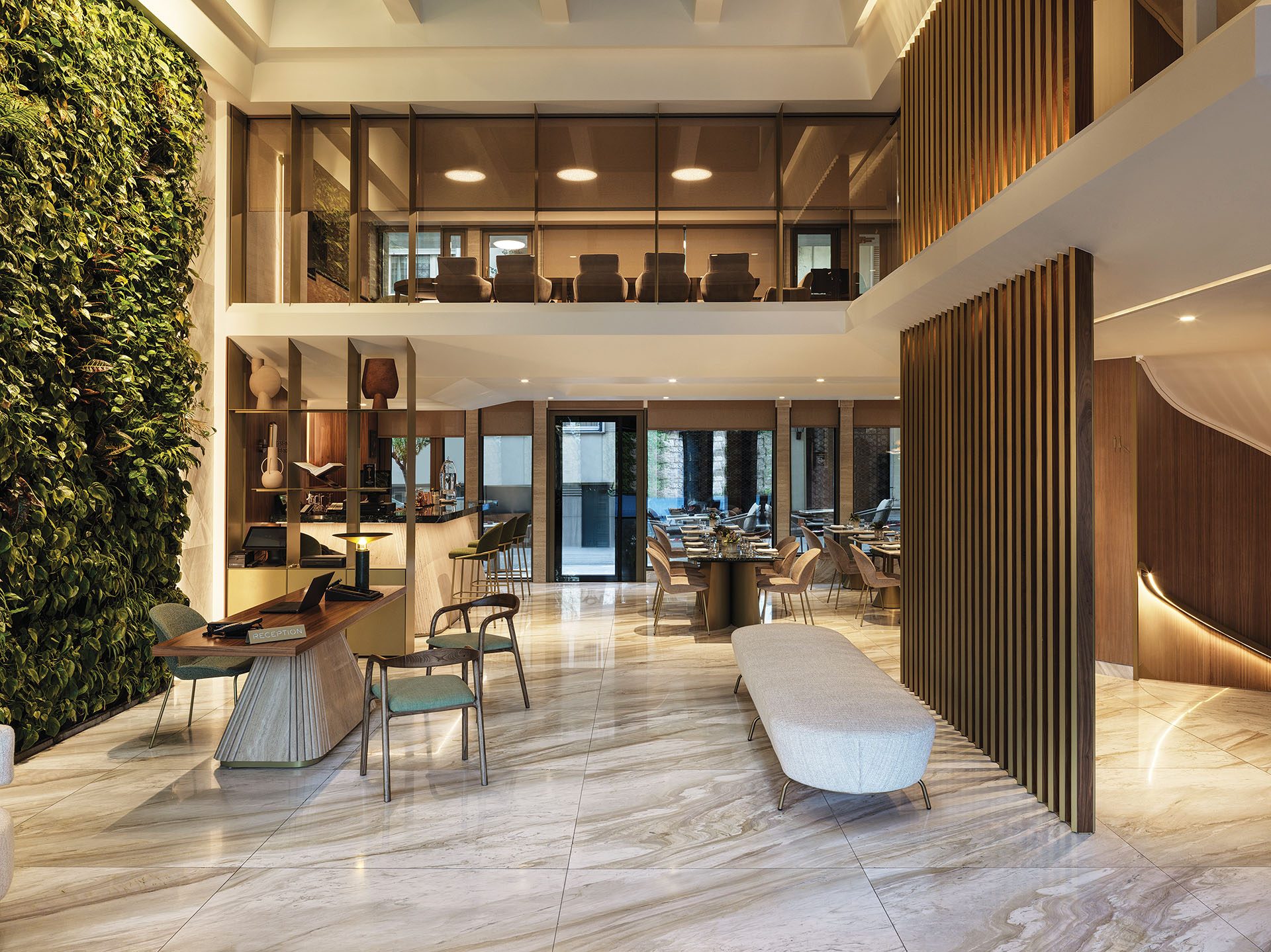 Double-height lobby with green wall and oak screen at Anthology of Athens