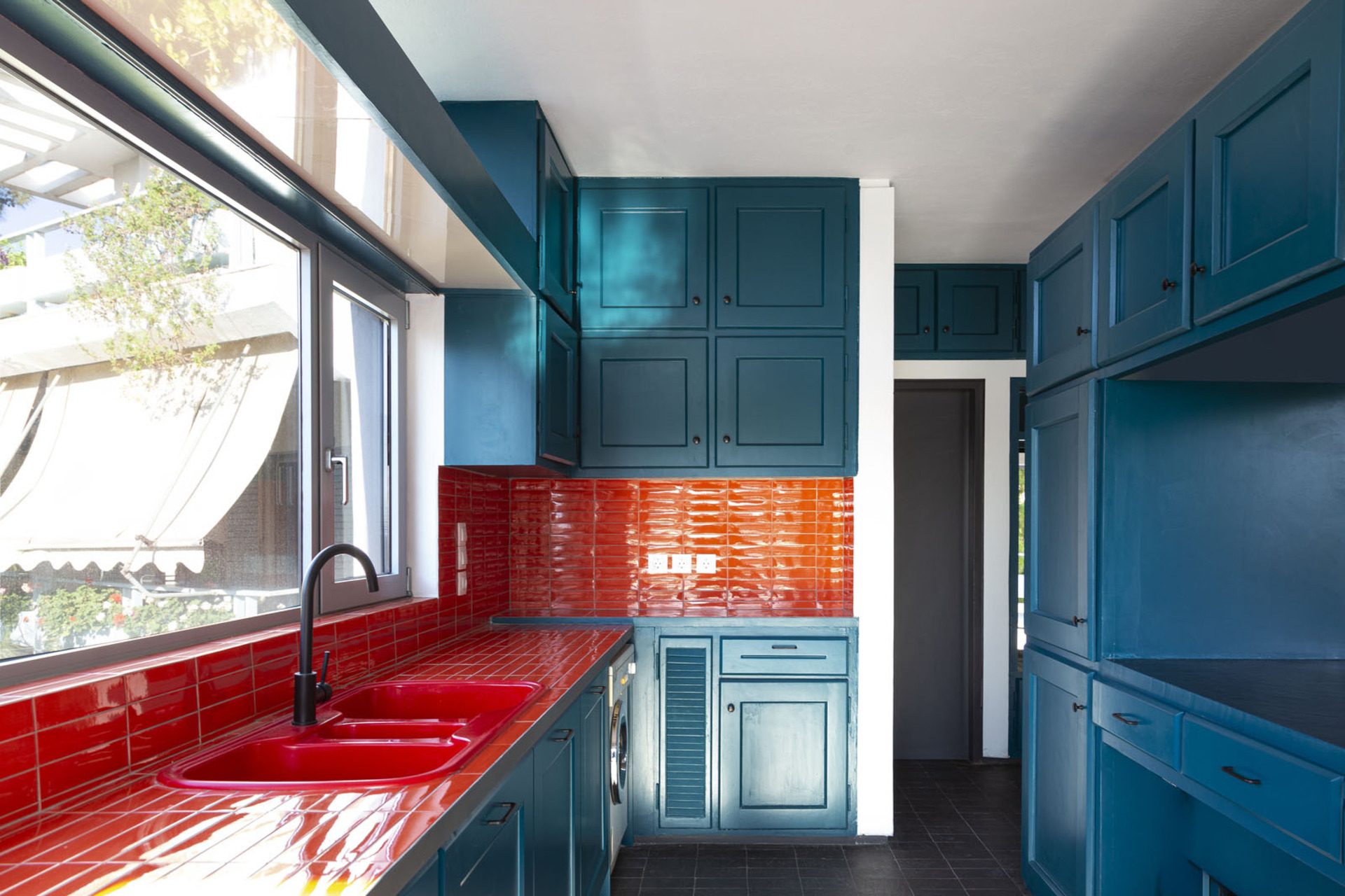 Petrol-blue kitchen with glossy orange tiles and red sink, Duplex Residence in Athens