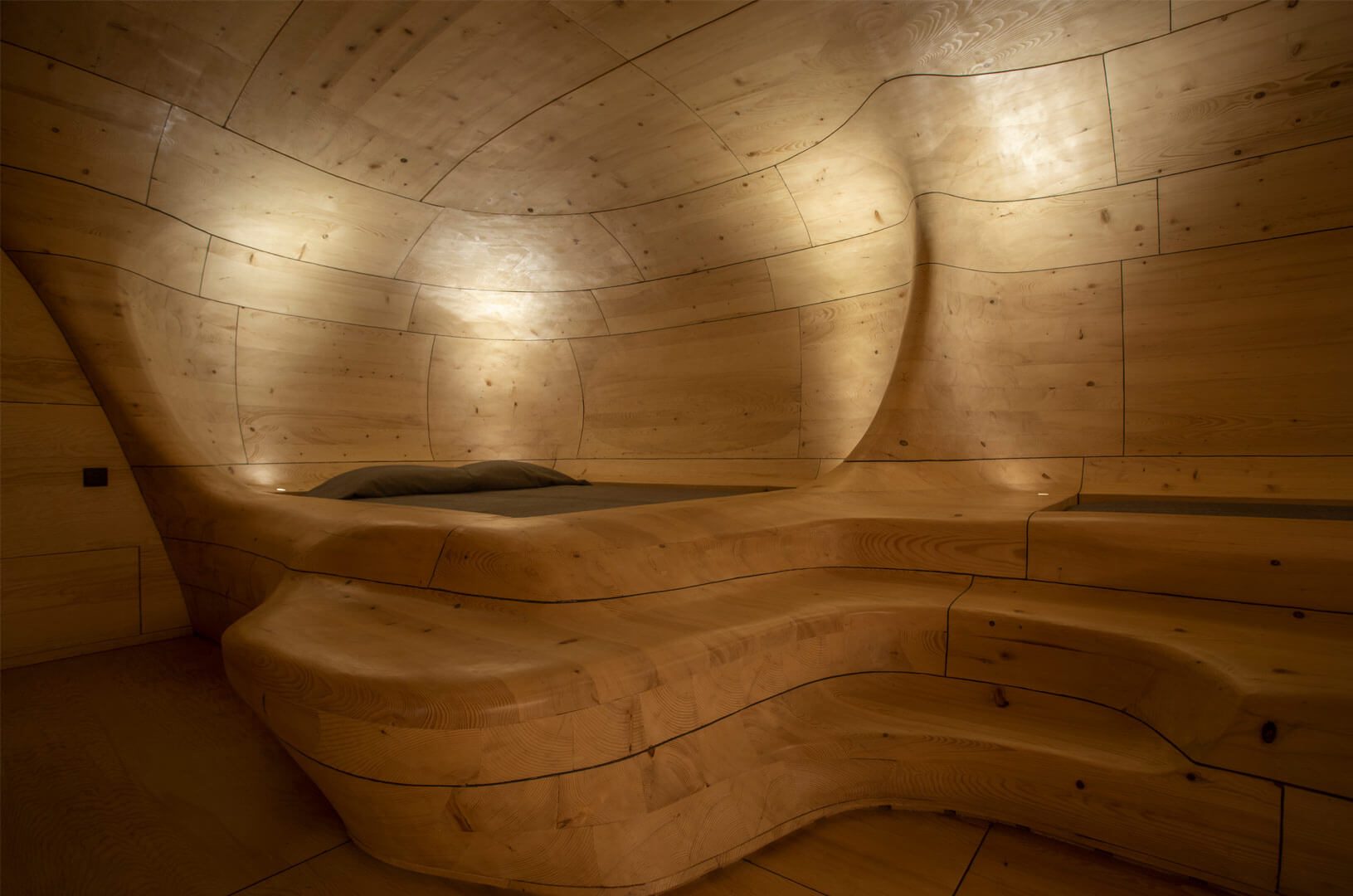 Hand-shaped spruce elements forming the curved walls of The Wooden Cave
