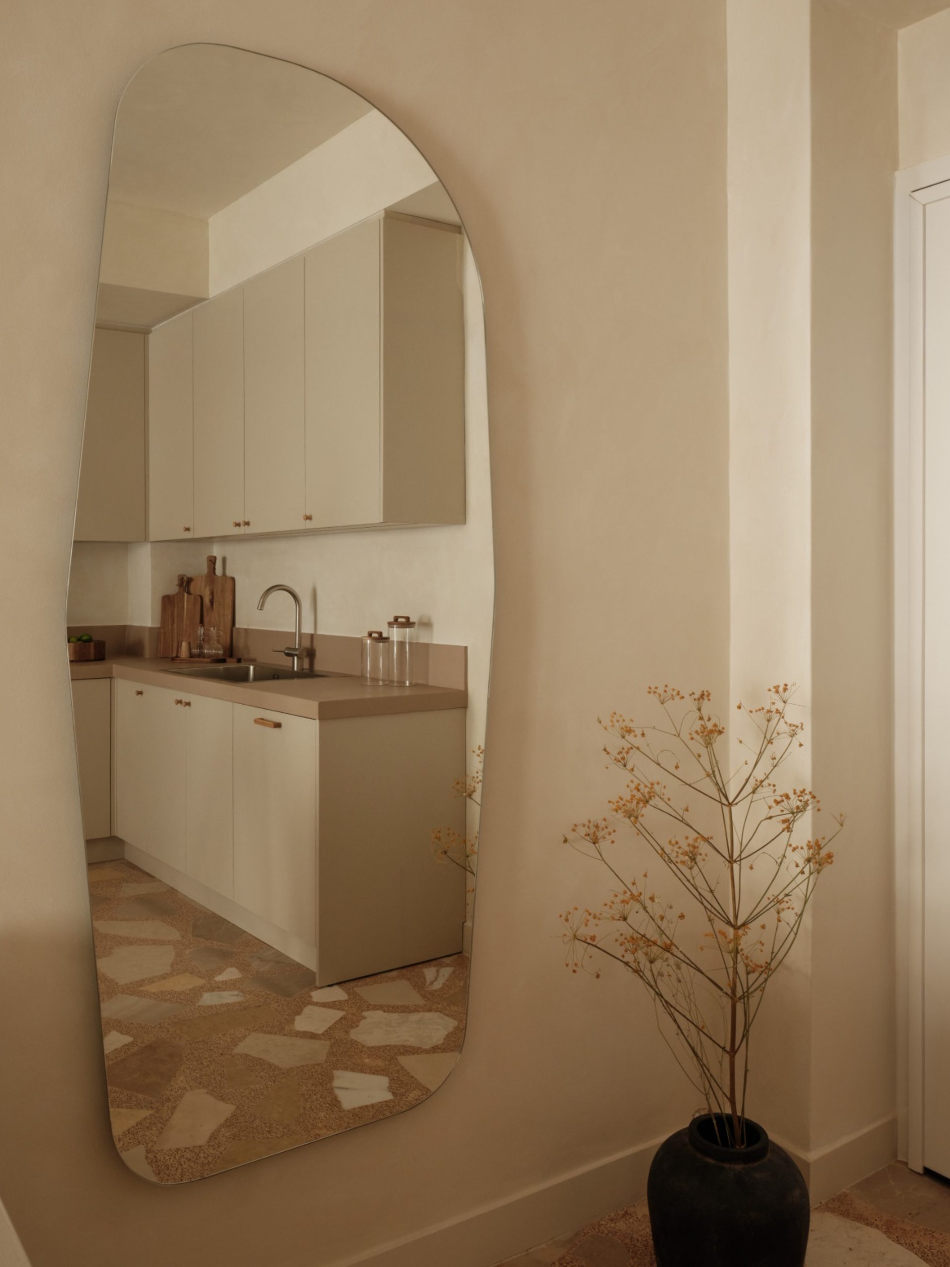 Thiseio Residence kitchen reflected in hall mirror above new palladiana floor