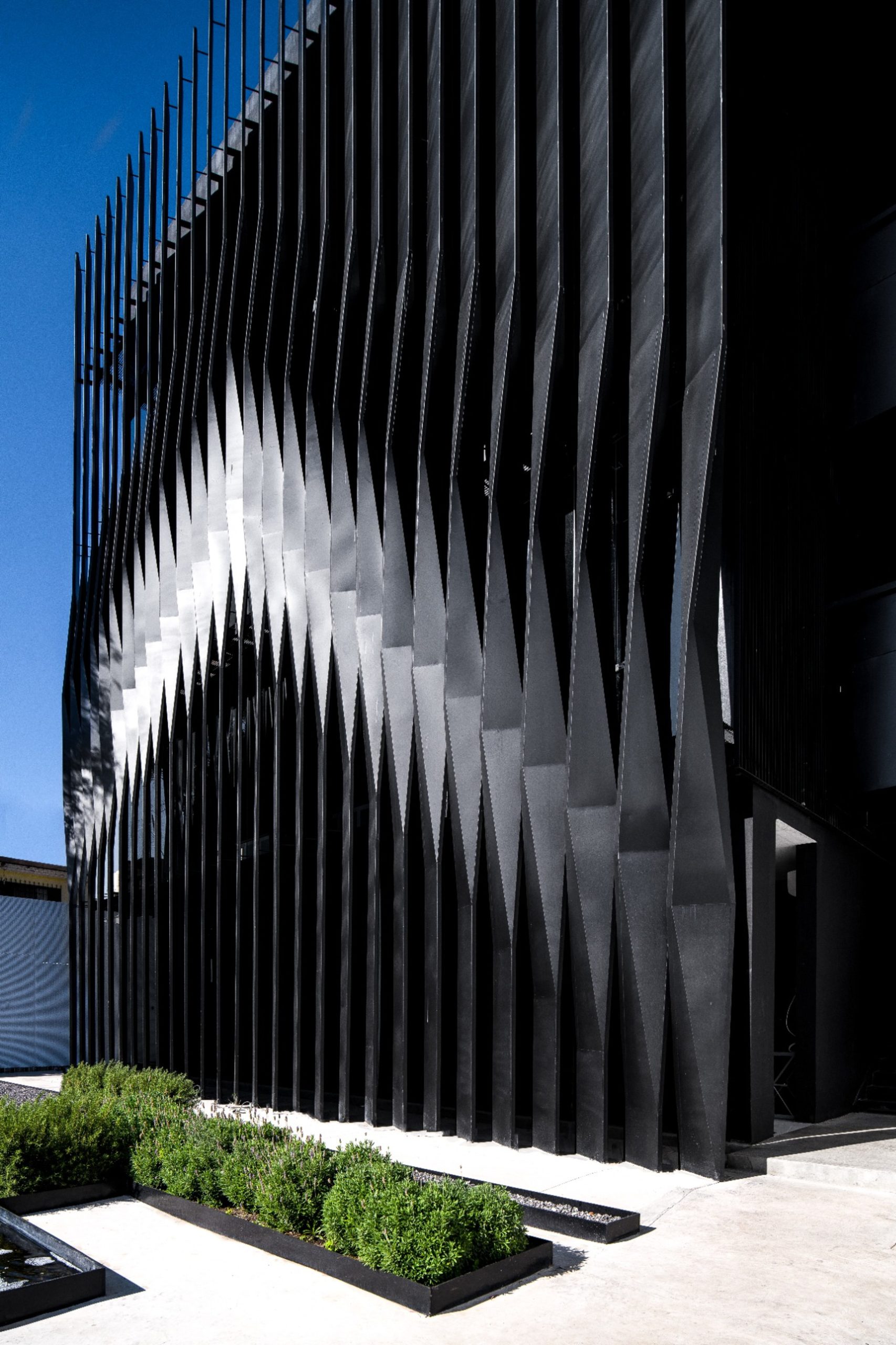 Rotated black metal slats on the façade of Torre Negra