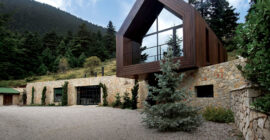 Periscope in Parnassus with timber lookout volume above a stone base