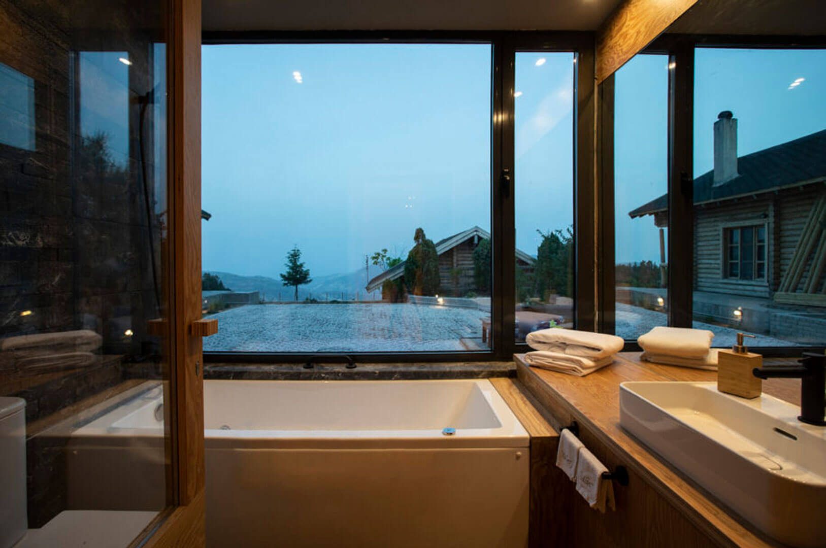 Bathroom with bathtub and mountain view at The Wooden Cave