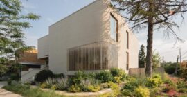 The Lens curved glass-block corner and beige brick volumes in Montreal