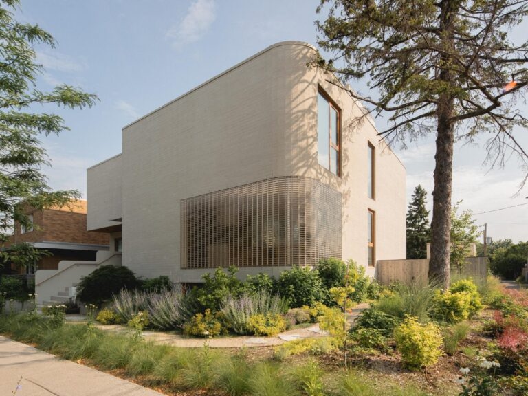 The Lens curved glass-block corner and beige brick volumes in Montreal