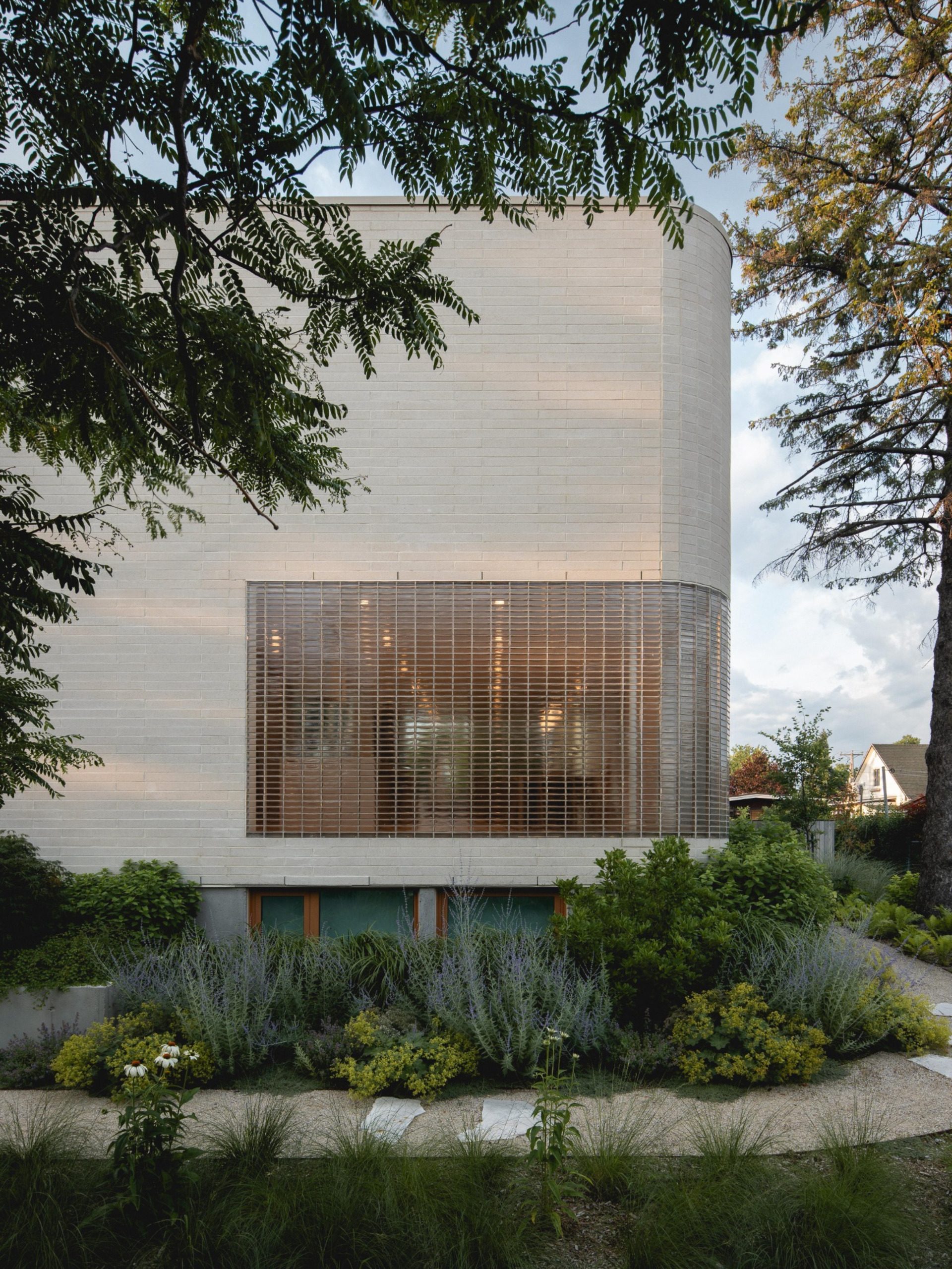 Curved glass-block screen on the south façade of The Lens