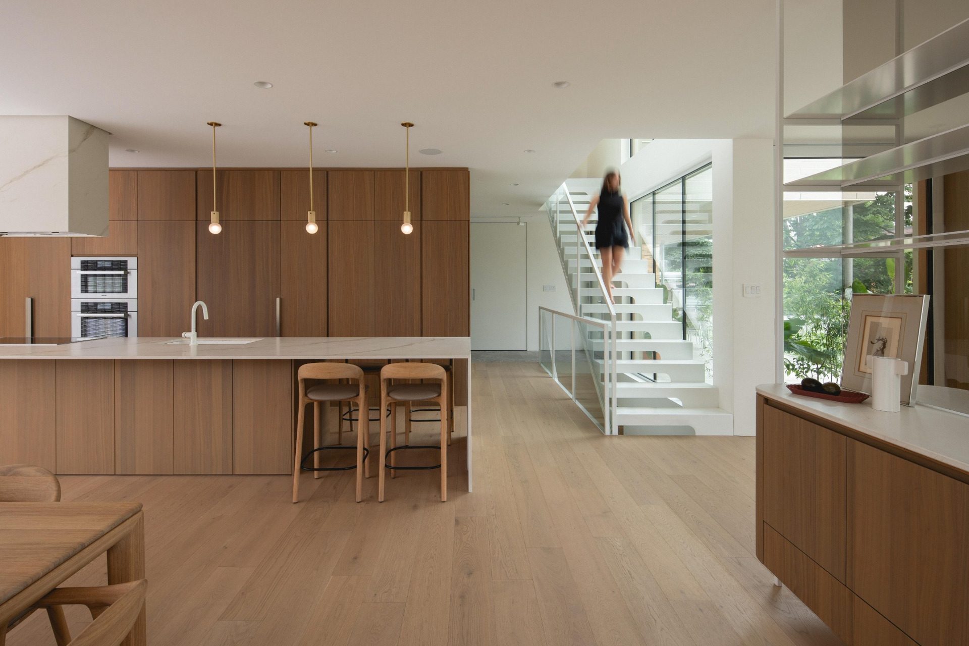 Open kitchen leading to the white steel staircase at The Lens