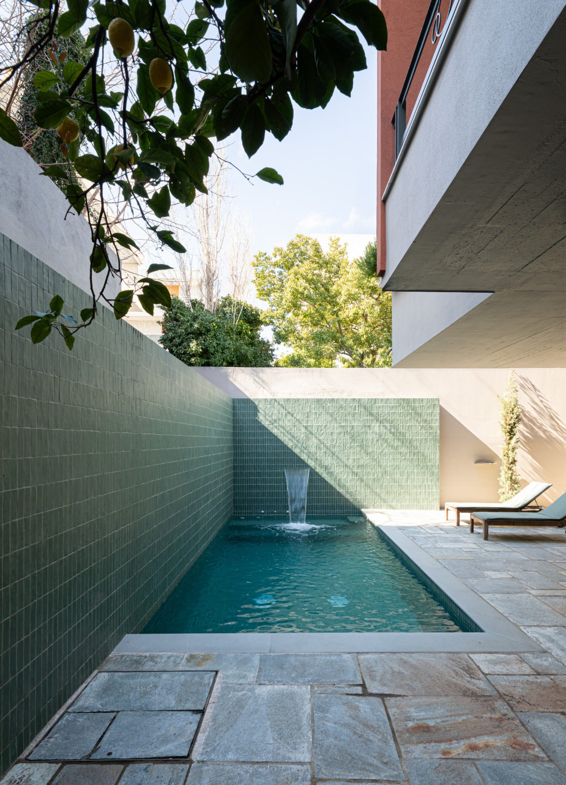 Narrow swimming pool with green tiled wall at the Chalandri residence