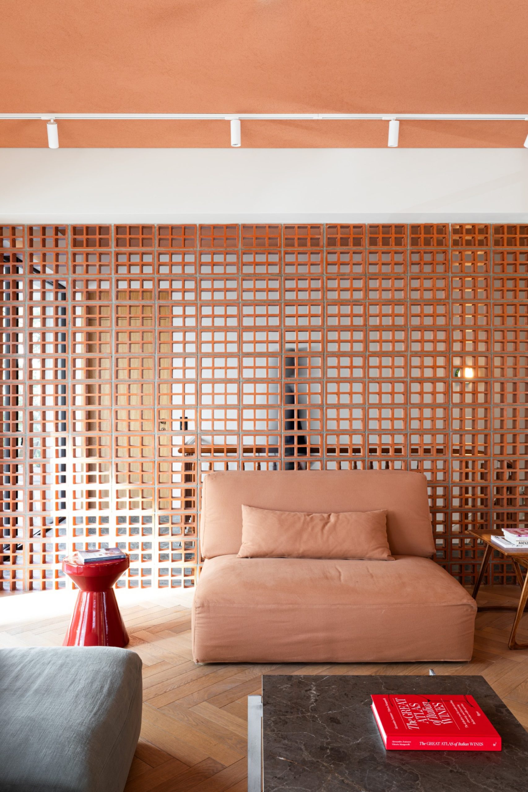 Living room framed by ceramic claustra screen in Chalandri residence