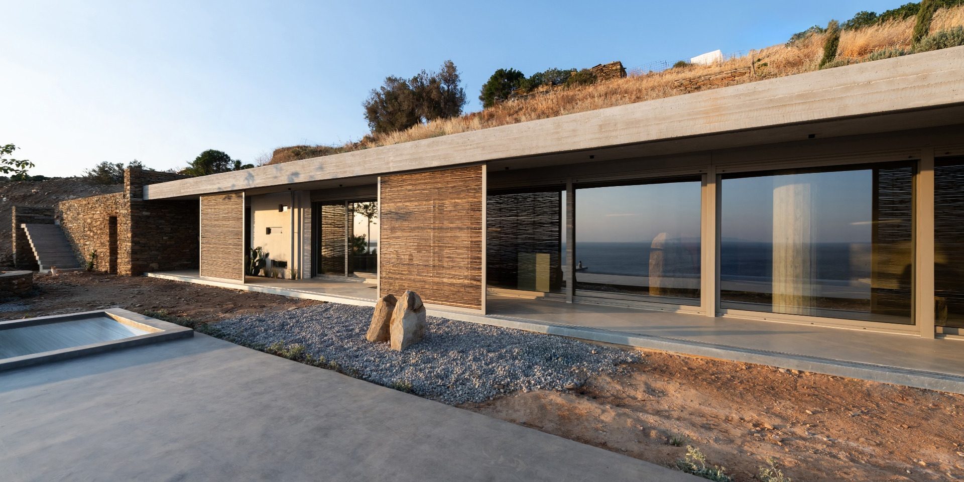 A-12-web West façade of residence A of The Passage with planted roof and bamboo screens