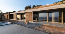 West façade of residence A of The Passage with planted roof and bamboo screens
