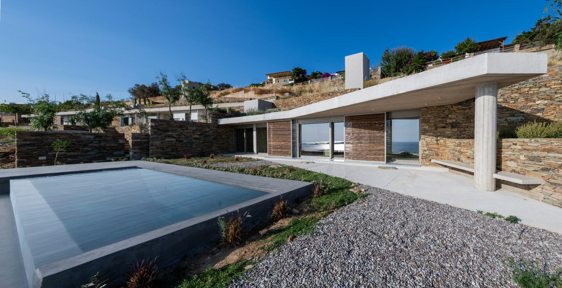Pool and terrace of residence B of The Passage with local stone walls