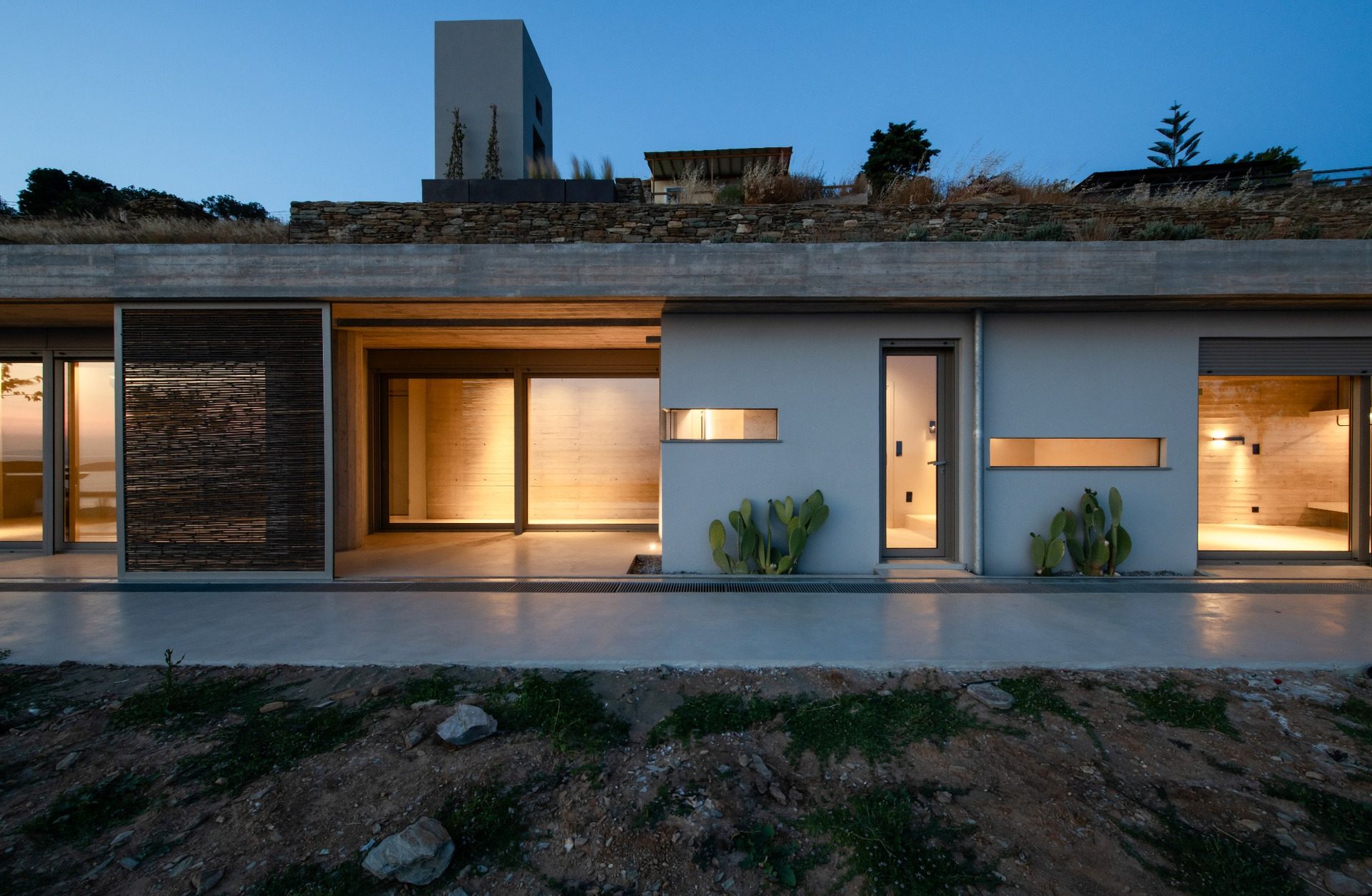 Residence C of The Passage at dusk beneath the planted roof