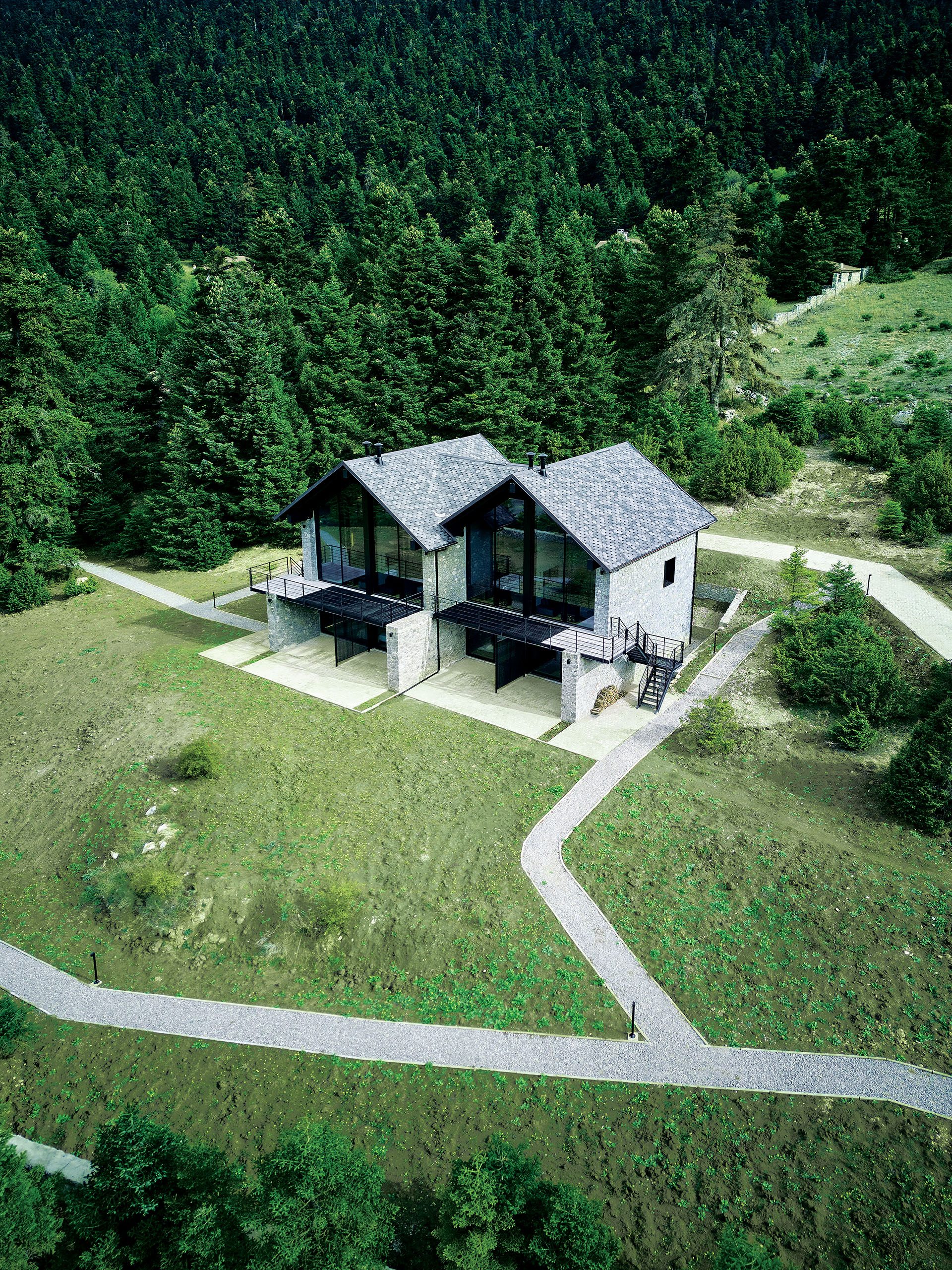 Aerial view of Hermitage 1310 on a green slope in Parnassos