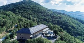 Aerial view of The Lynx Mountain Resort on a forested hill above Florina
