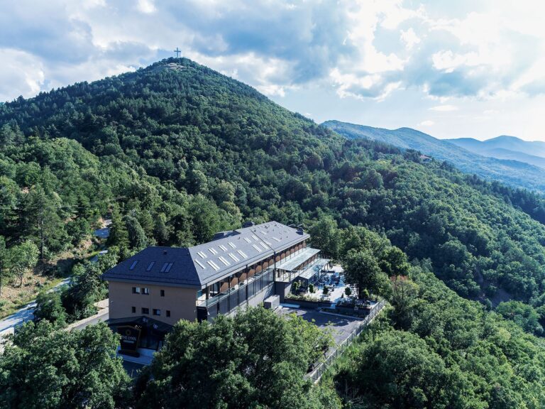 Aerial view of The Lynx Mountain Resort on a forested hill above Florina
