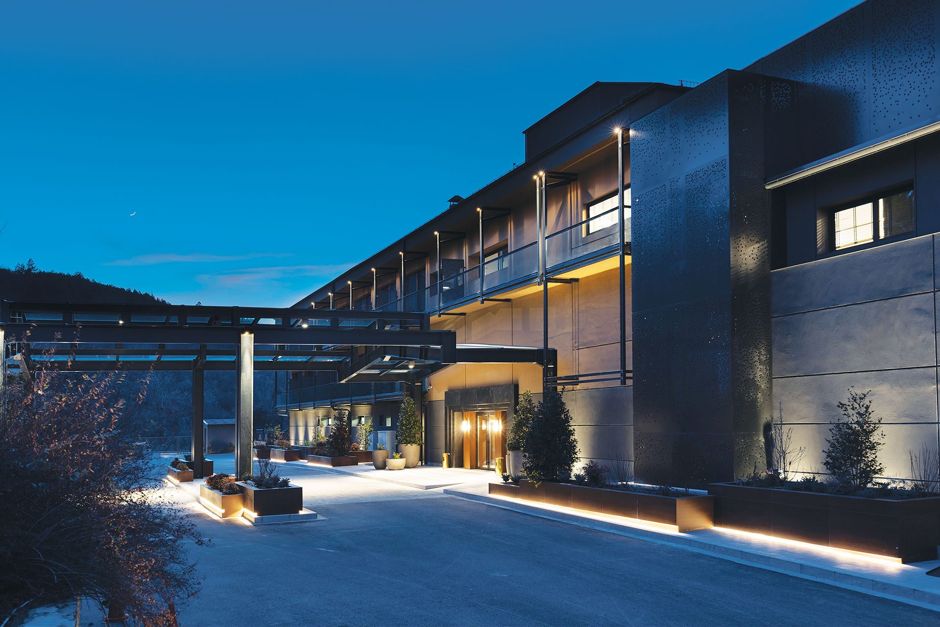 Entrance and dark metal façade of The Lynx Mountain Resort at night