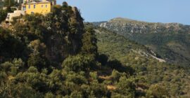 Paratiritirio yellow stone house above a gorge in Isna, Mani