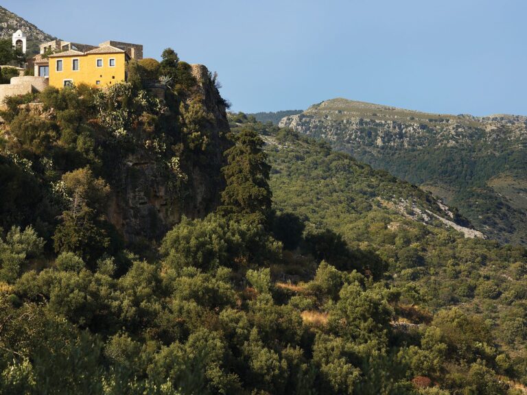 Paratiritirio yellow stone house above a gorge in Isna, Mani