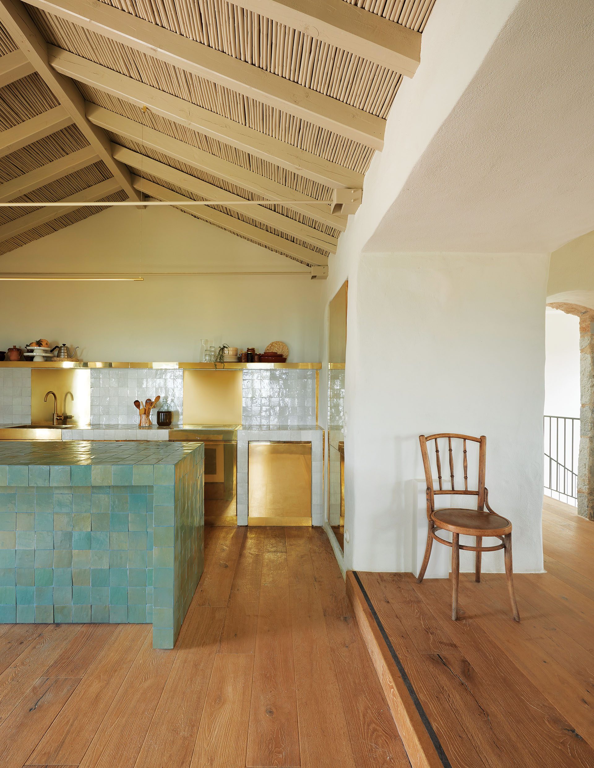 Kitchen with green zellige island under timber roof at Paratiritirio