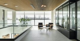 Upper-level open-plan area with glass balustrade at KAFEA TERRA offices