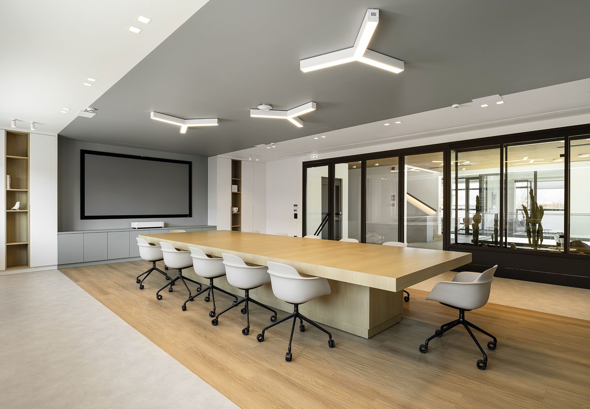 Meeting room with long timber table and glazed partitions at KAFEA TERRA offices