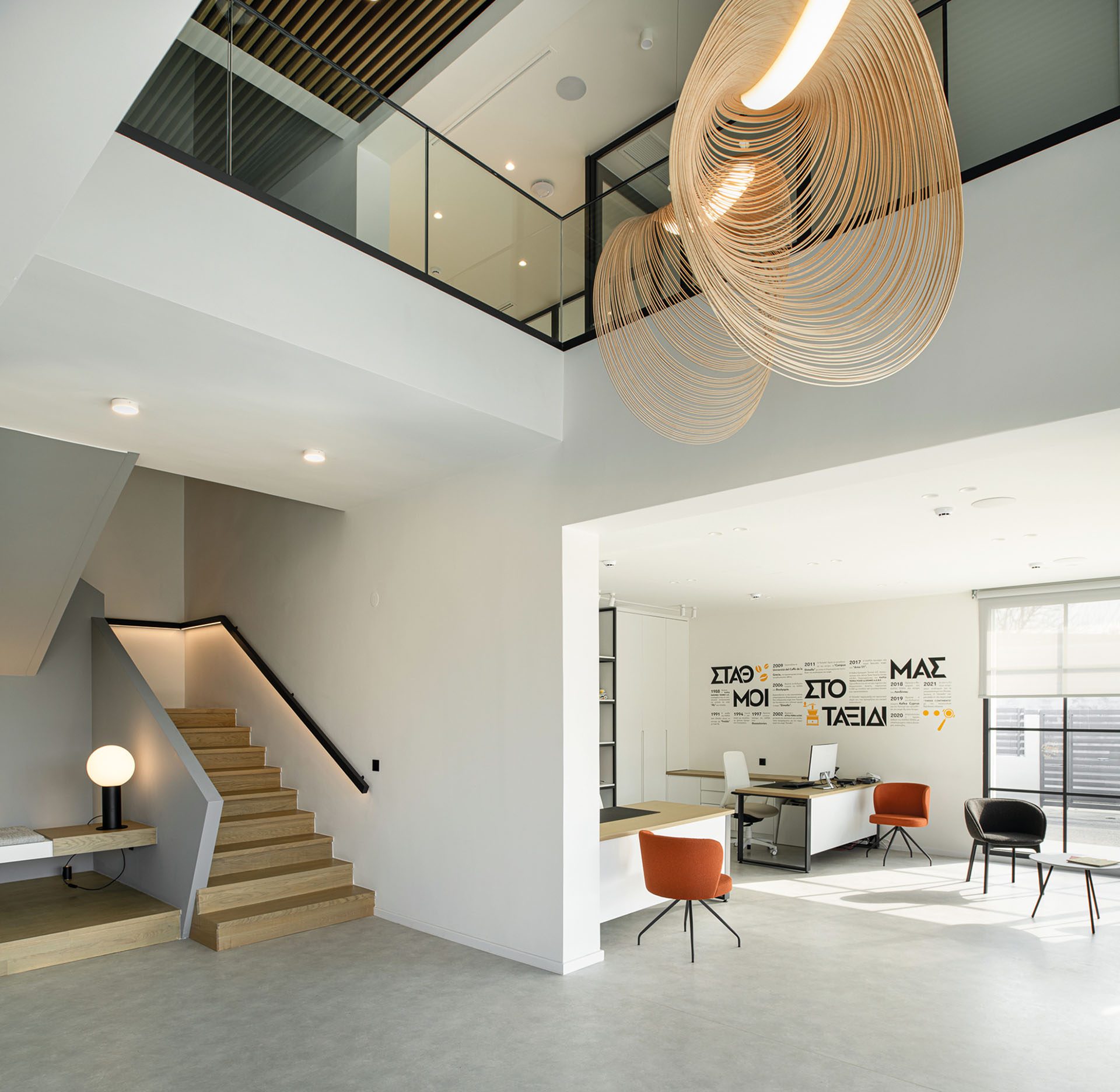 Double-height space with timber stair and mezzanine at KAFEA TERRA offices