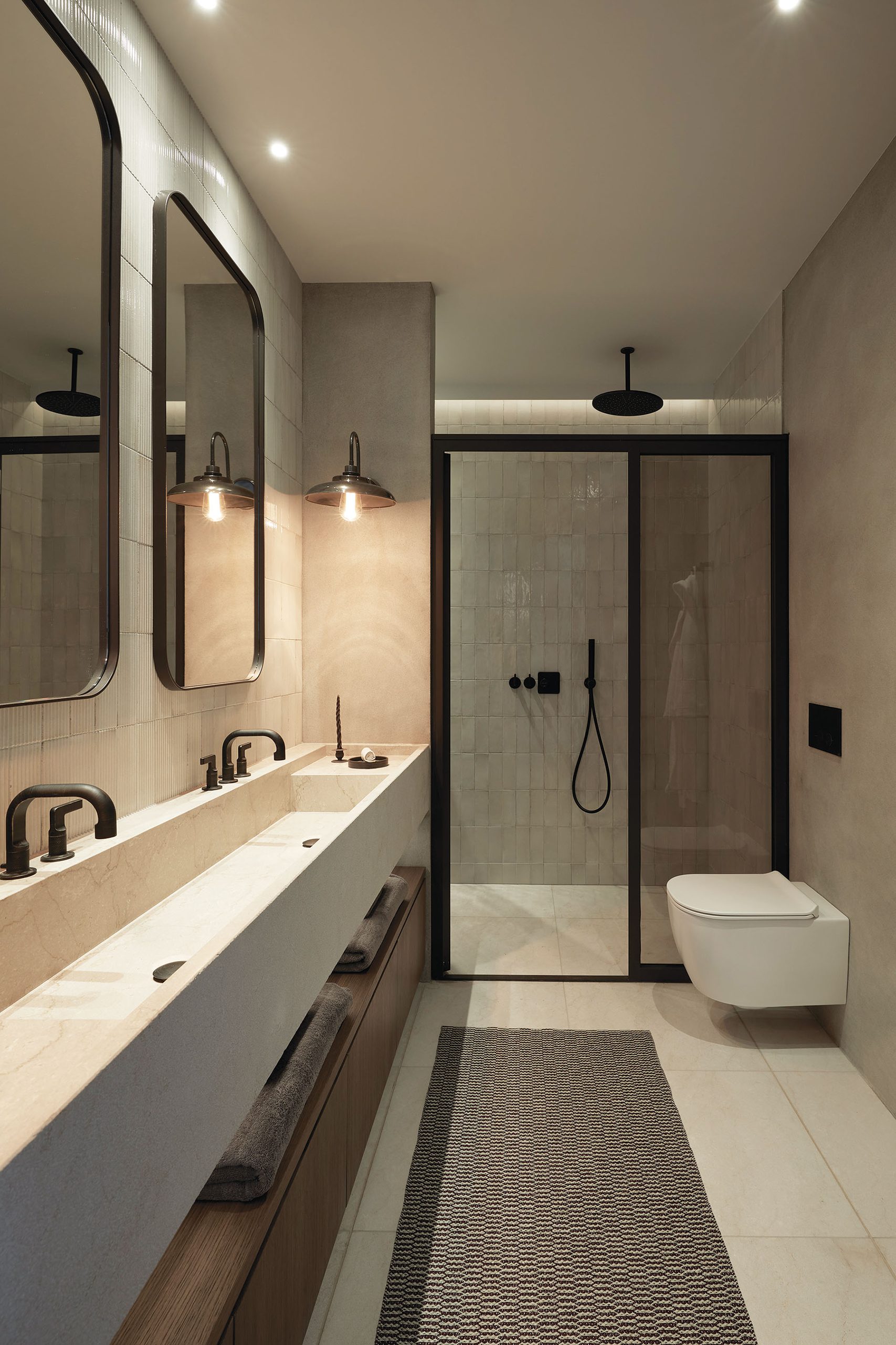 Bathroom with long basin and glass shower at Patrion House