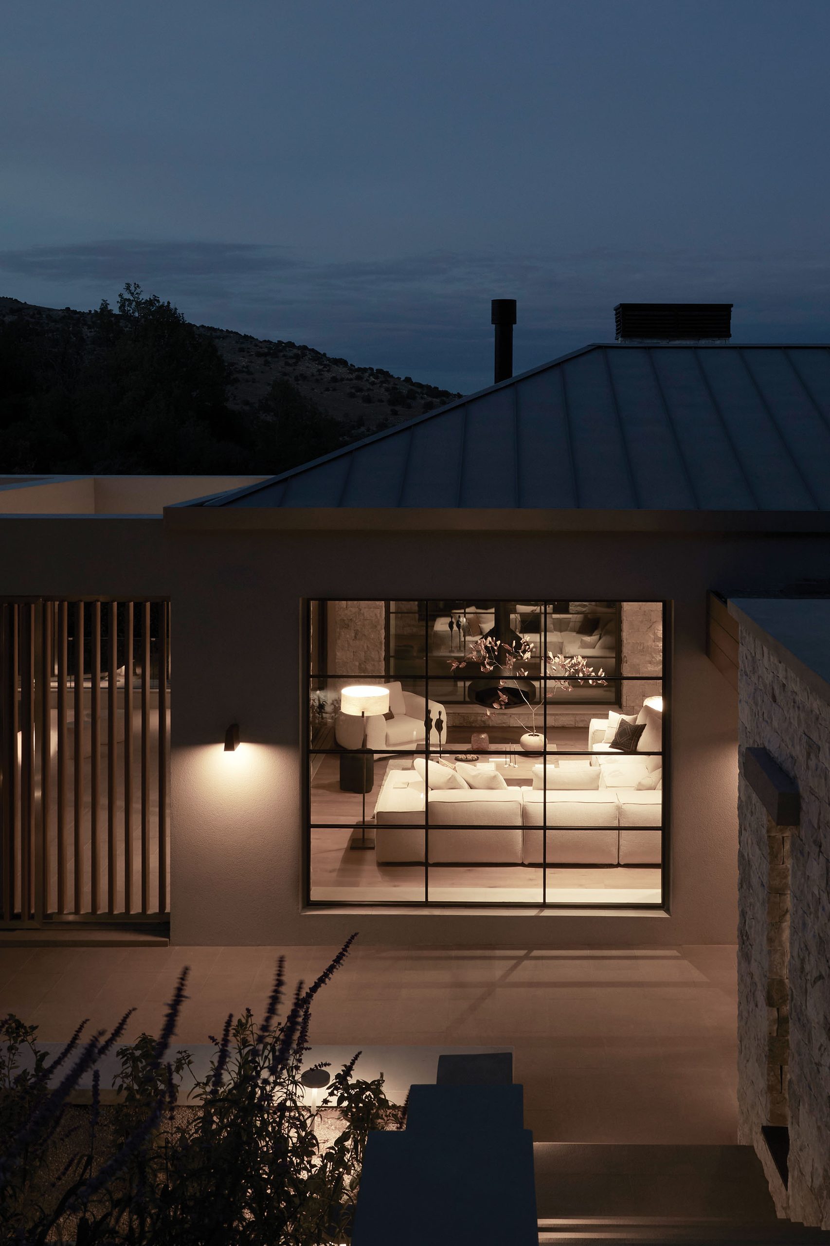 Patrion House lit living room seen from outside at night