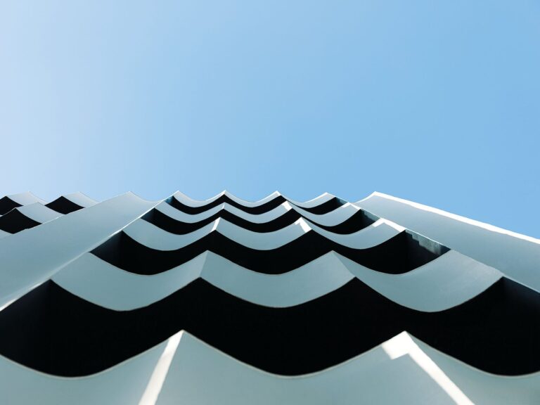 Undulating white façade of The Social Athens Hotel against the sky