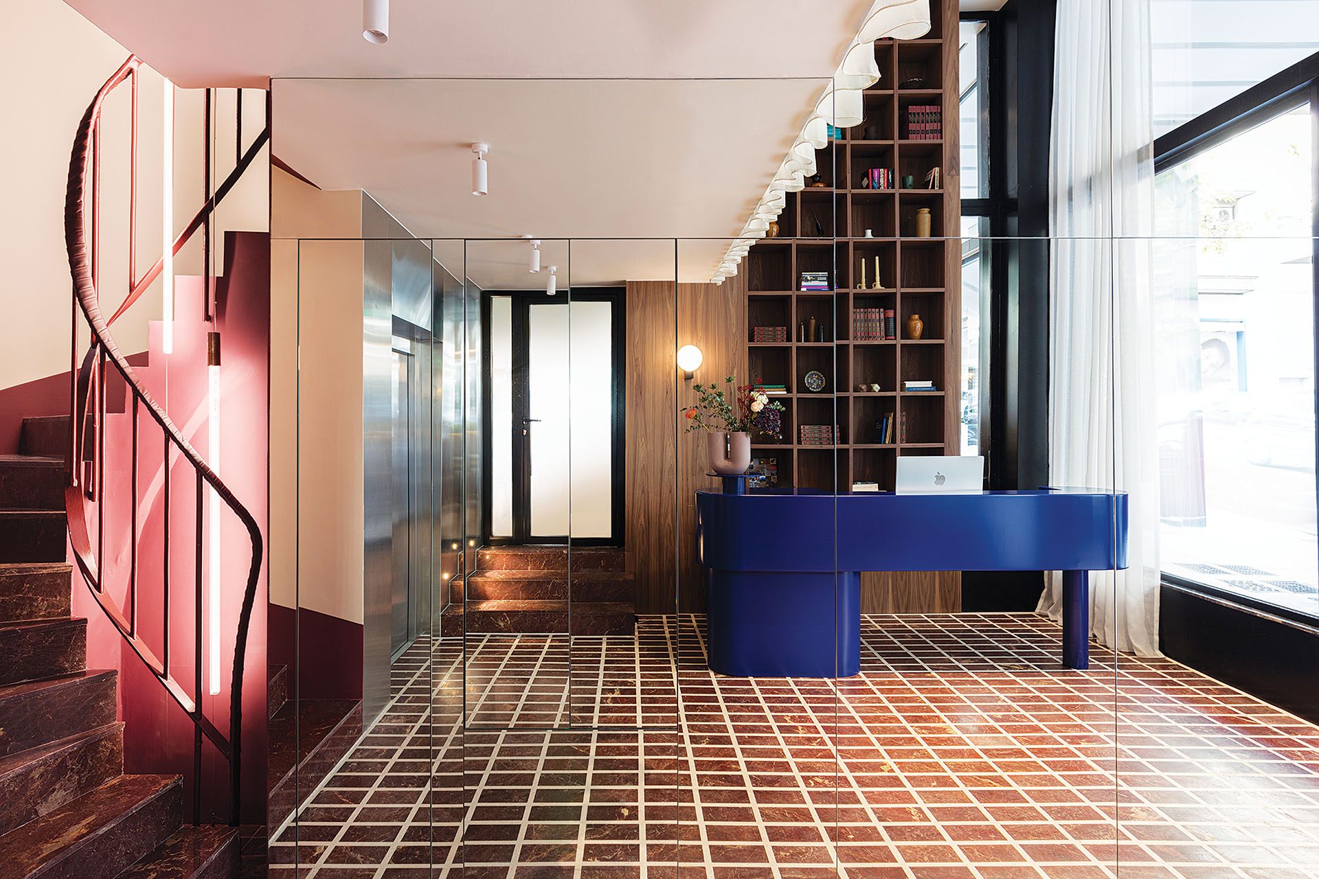 Double-height reception with red marble stair at The Social Athens Hotel