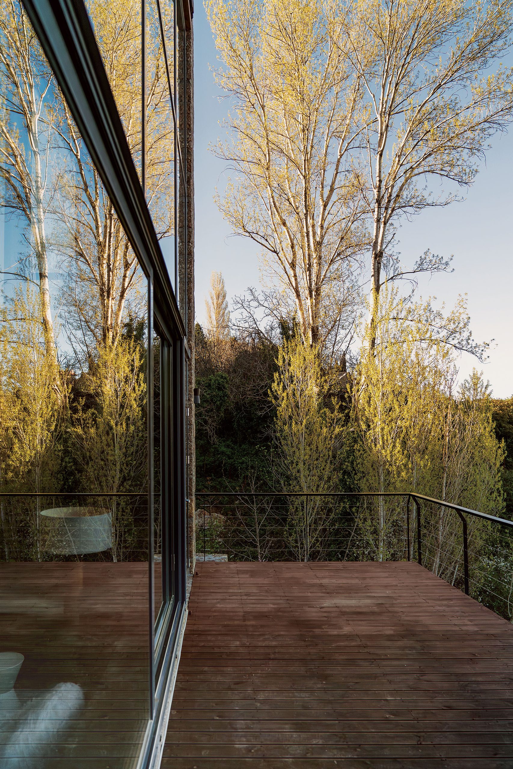 Suspended timber deck beside the glazed façade at Slope